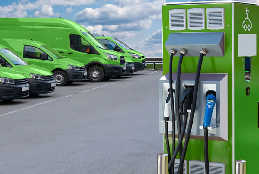 row of electric bikes and scooters at a charging station